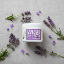 Load image into Gallery viewer, Lavender Dreams scented coconut lotion with fresh lavender sprigs on soft grey linen
