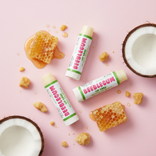 Load image into Gallery viewer, 3 Beeblegum Lip Care balm sticks with honeycomb and coconut on pastel pink surface
