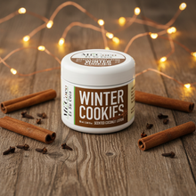 Load image into Gallery viewer, Winter Cookies scented coconut lotion with cinnamon sticks and cloves on rustic wood

